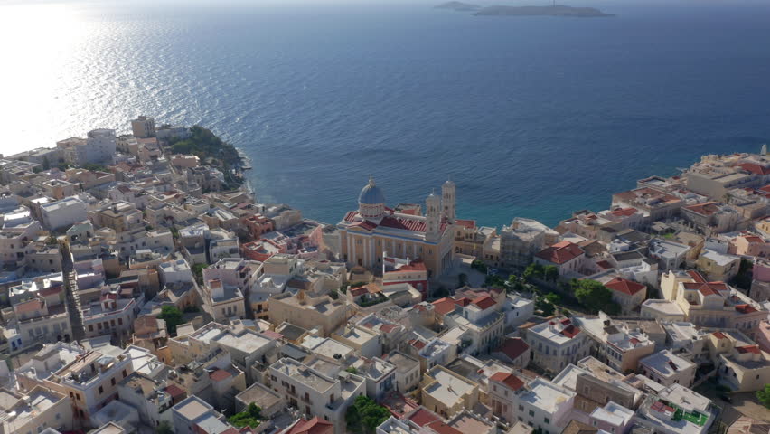 Aerial: Slow panning drone shot of Saint Nicholas church in Ermoupoli of Syros island, Greece