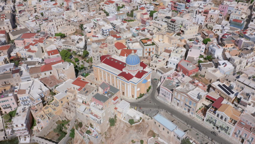 Aerial: Slow panning drone shot of Saint Nicholas church in Ermoupoli of Syros island, Greece