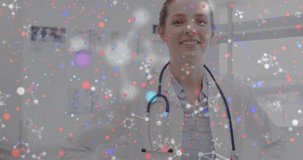 Animation of dna strand and molecules over happy caucasian female doctor with stethoscope. Medicine, health and digital interface concept, digitally generated video.