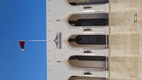 Vertical Video, Royal Opera House Muscat, Oman. Building and National Flag