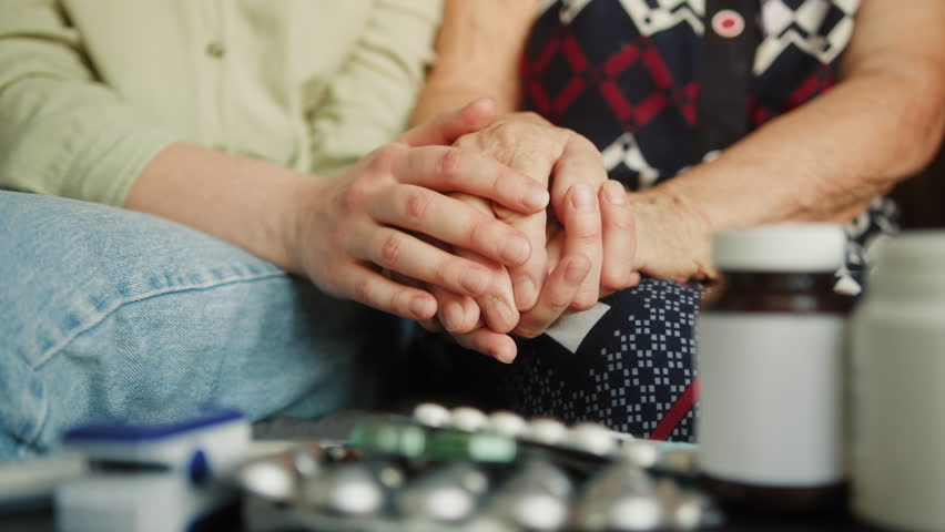 Close up hand of young woman or nurse home care holding senior grandmother give support empathy to elderly lady or older people in assisted living home care mental health relief concept. Royalty-Free Stock Footage #1106085717