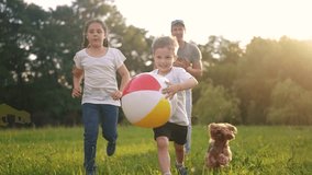 happy family. children and parents run in the park play ball. happy family kid concept. boy runs on grass in park holding the ball. group of children and parents family play in park run dream - Powered by Shutterstock - Get 15% off with code: PIKWIZARD15