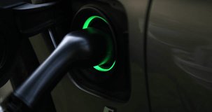 Electric charger flashes green-blue in vehicle charging connector 4k movie