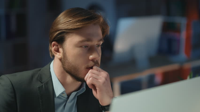 Young bearded office executive focused on task browsing internet computer desktop networking at night office. Coworking space. Businessman. | Shutterstock HD Video #1106090299