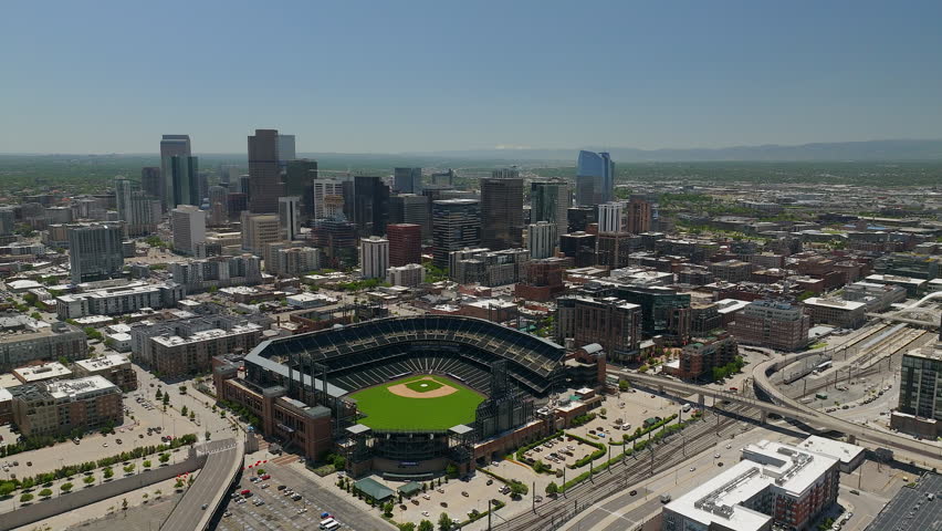 Downtown Denver Coors field Colorado Rockies baseball stadium Rocky Mountain landscape Mount Evans aerial drone cinematic foothills Colorado cars traffic spring summer circling left