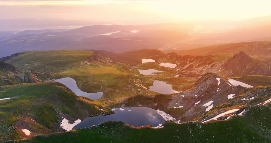 Sunrise  over bulgarian mountain peaks, hills, Seven Rila Lakes and clouds and fog, 4K video nature of Bulgaria