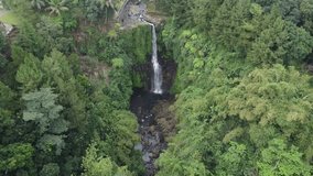 The aerial view of Orak-arik Waterfall in Baturaden, Central Java, Indonesia. This aerial video was taken on August 6, 2021 by a professional. This video contains view of a high waterfall in tropical