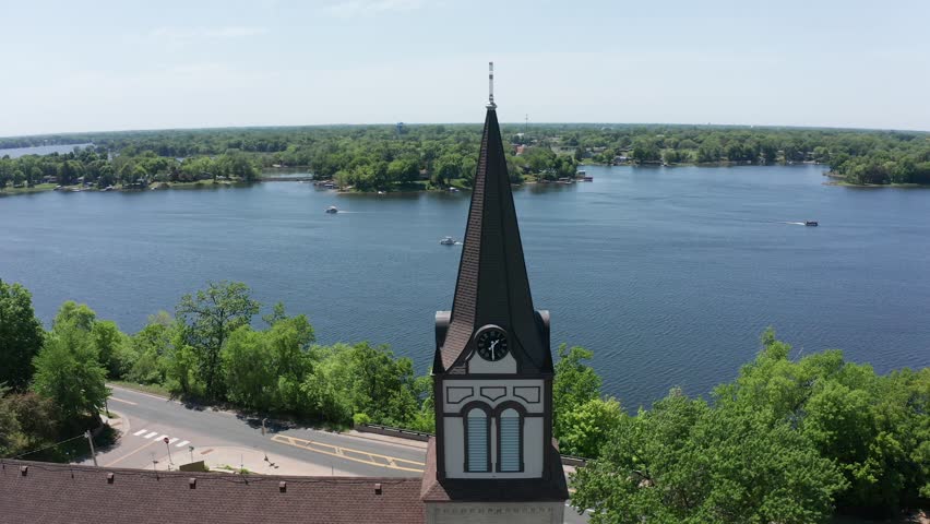 Aerial reverse pullback and panning shot of a Lutheran Church on the lake in Center City, Minnesota. 4K