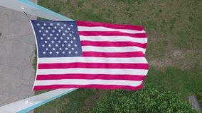 Aerial ascending video of American Flag on windy day, Rocky Point RI
