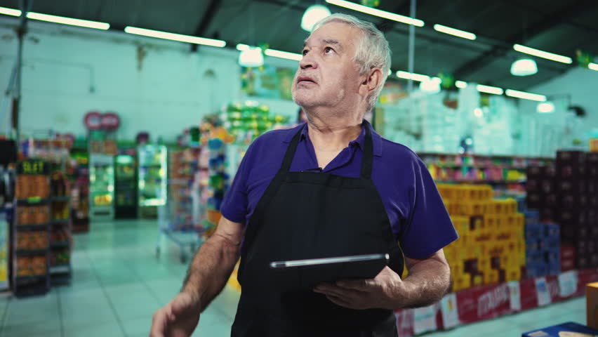 Stressed business owner of supermarket chain feeling pressure facing difficulties in grocery store operations. Portrait of a frustrated manager with unshaven beard and gray hair Royalty-Free Stock Footage #1106104293