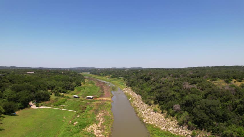Aerial footage flying over the Pedernales River near Spicewood Texas. The Pedernales River is extremely low.