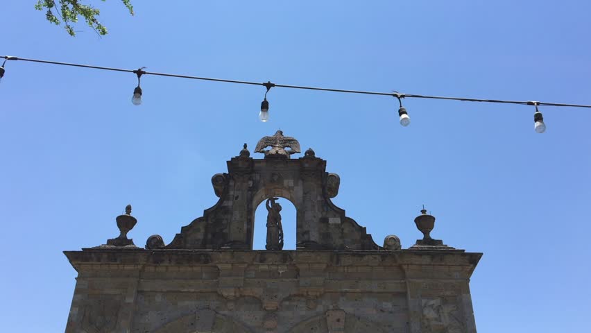 Arcos de Zapopan limestone monument with tourist, Guadalajara, Mexico