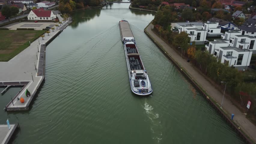 barge floats on the channel, water logistics, cargo transportation