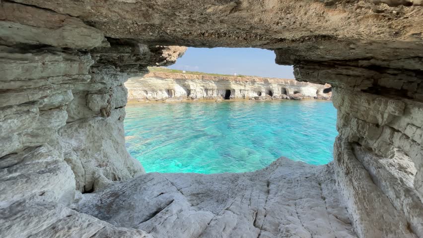 A sea view is visible from a small cave hole The sea water is very clean and clear it's a nice place to have a vacation Beach for tourists Royalty-Free Stock Footage #1106117893