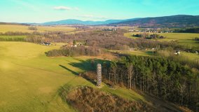 Wooden lookout tower in Hermanice on sunny spring day, Czech Republic. Aerial 4K footage from drone flight