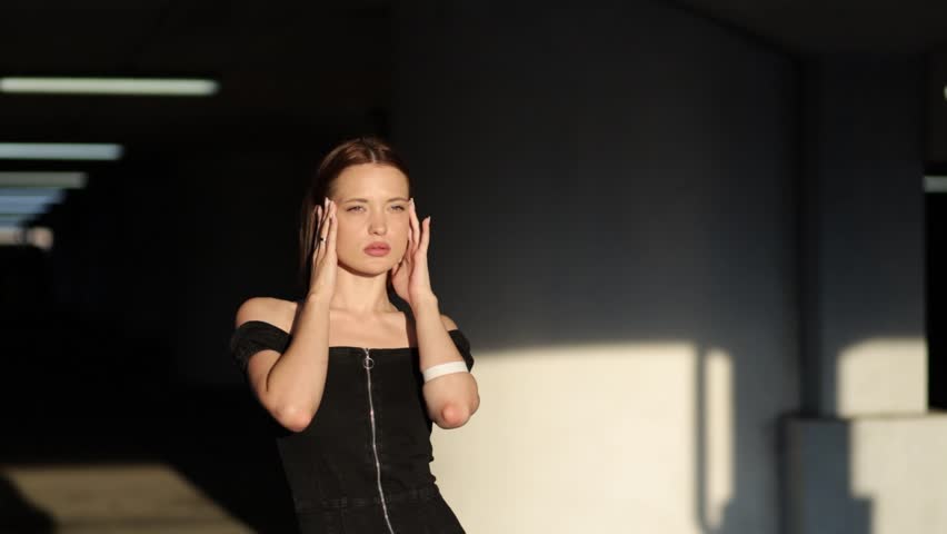 beautiful sexy woman in black dress posing in sunlight. The most beautiful appearance of a girl.