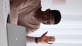 Vertical video. Online coach. Internet call. Business communication. Cheerful man employee discussing corporate project at laptop virtual meeting conference at office workplace. - Powered by Shutterstock - Get 15% off with code: PIKWIZARD15