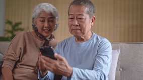 Senior couple watching on cell phone surprising a good news
