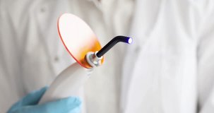Dentist holding curing light machine in clinic 4k movie