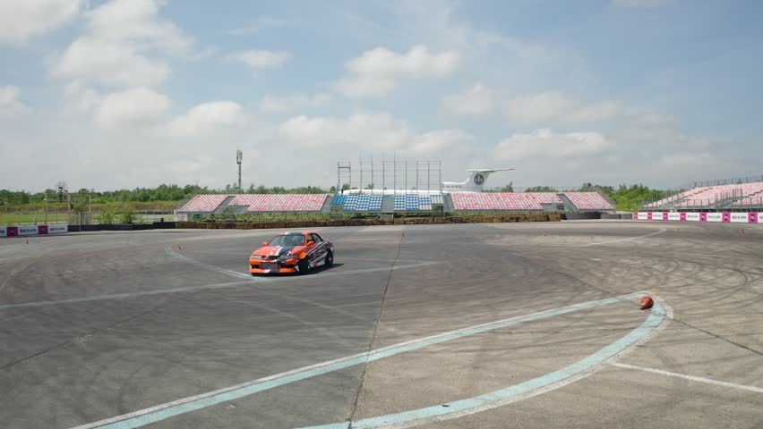 shooting from a copter, racing car in the stadium, drifting