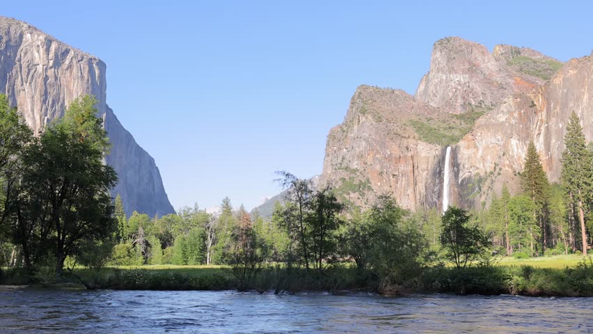 The Merced River as it runs through Yosemite National Park in California. El Capitan and Bridalveil Fall in the background. This video Loops seamlessly. Royalty-Free Stock Footage #1106137045