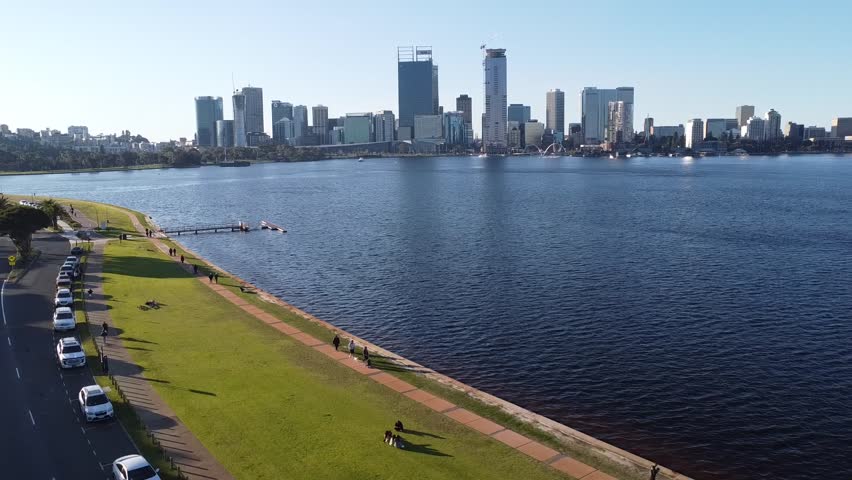 Drone shot rising over Swan River with skyline of Perth, Western Australia and South Perth foreshore