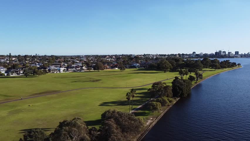 Drone shot across and South Perth, foreshore Swan River to skyline of Perth, Western Australia foreshore Royalty-Free Stock Footage #1106140917