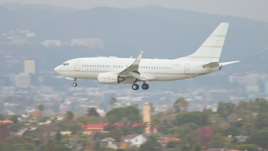 Generic White 737 Type Airliner with No Markings on Final Approach Arriving and Landing on a Runway at a Los Angeles California Airport
