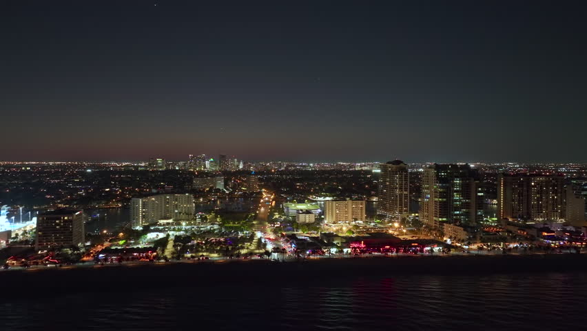 Las Olas Beach in Fort Lauderdale, Florida at night. American southern seashore with brightly lit luxurious hotels and apartment buildings. Tourist infrastructure in southern Florida, USA Royalty-Free Stock Footage #1106143689