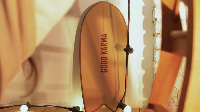 Short board for active surfing in the ocean stands against a wall inside a cozy apartment. Close-up 
