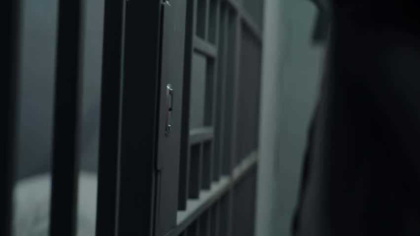 Close up of jailer opening and locking prison cell with keys. Prisoner, criminal goes inside. Inmate serves imprisonment term. Working in detention center, correctional facility. Justice system. Royalty-Free Stock Footage #1106150211