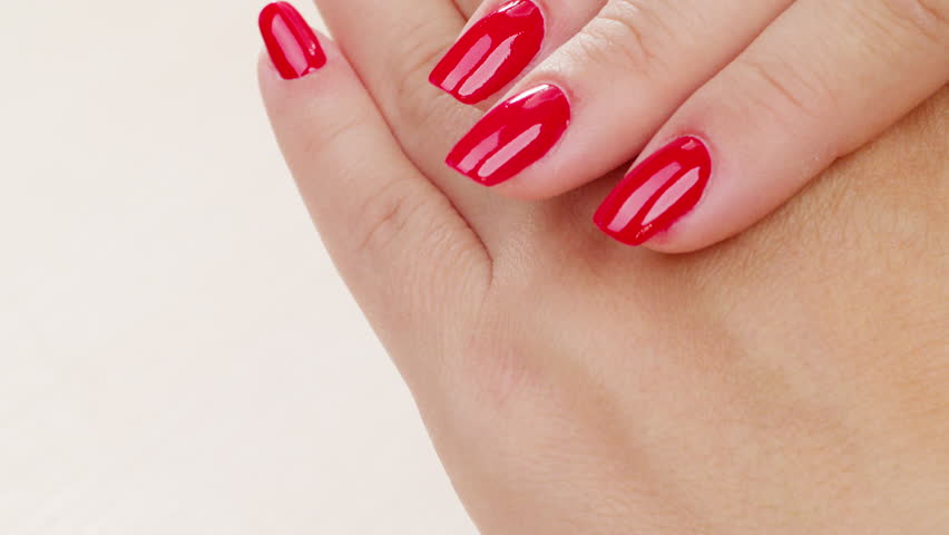 Female hands with fashionable manicure of red color . Woman shows her new red manicured nails, closeup. Beauty of nails. Classic red manicure.  Royalty-Free Stock Footage #1106153613