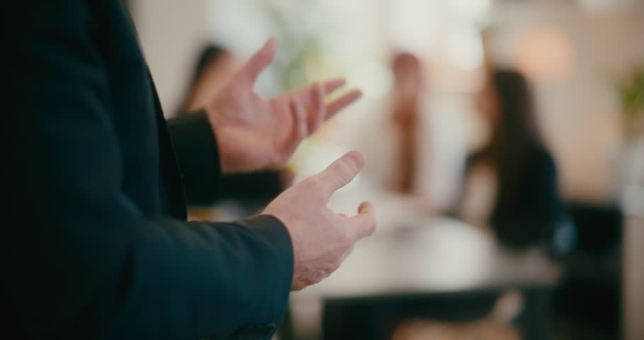 Hands of businessman gesturing in office.