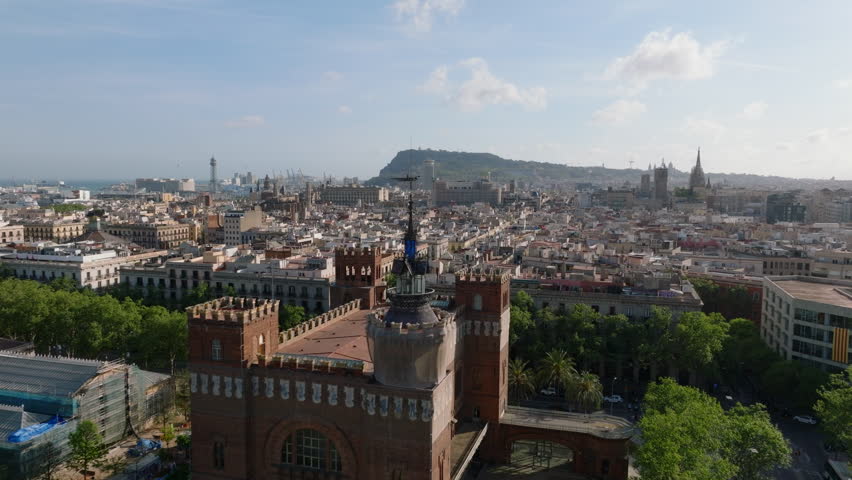 Fly around historic landmark, Castell dels Tres Dragons. Aerial view historic buildings in city and harbour in background. Barcelona, Spain