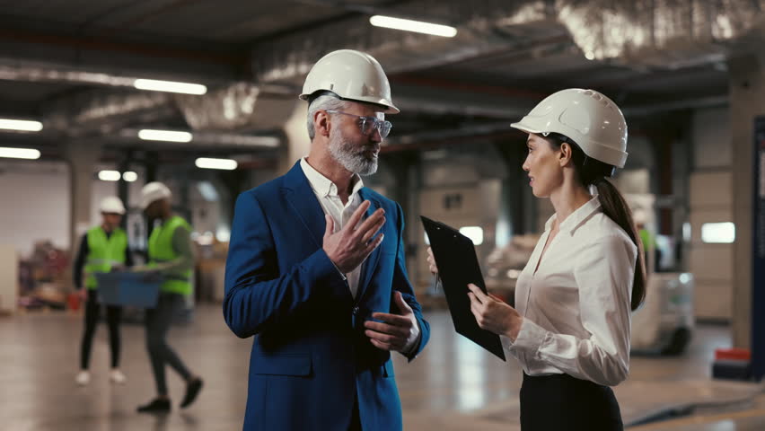 Handsome Caucasian Mature Businessman Confidently Signs an Investment Contract with Female Partner in the Logistics Center. Successful Deal and Partnership. Merger Acquisition Business Concept.