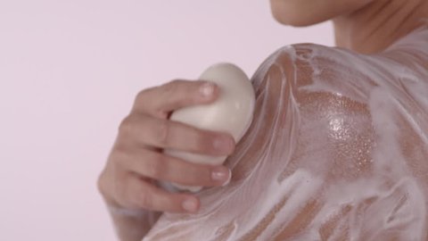 Close Up: Attractive Female Soaps Her Upper Arm And Shoulder With Soap Bar