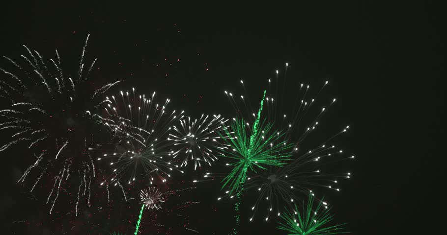 Fireworks in dark sky after celebration. The colors are red, green and white