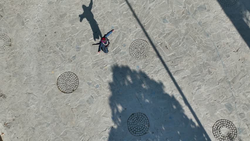 Full aerial view of the man and his shadow playing the zeybek, the most important folk dance in Turkey.