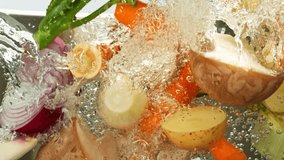Super Slow Motion of Falling Vegetable Into Boiling Water. Concept of Vegetable Broth Inside Stainless Steel Pot. Filmed on High Speed Cinema Camera, 1000 fps. - Powered by Shutterstock - Get 15% off with code: PIKWIZARD15