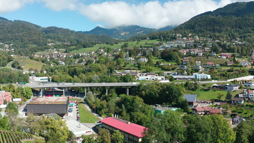 Aerial flight over Montreux City bridge towards mountains and villages. Alps Switzerland.