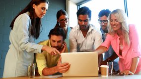 Animation of map and geometric shapes over diverse coworkers discussing reports on laptop in office. Digital composite, multiple exposure, global, planning, teamwork and technology concept. - Powered by Shutterstock - Get 15% off with code: PIKWIZARD15