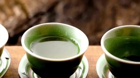 Serenity in Motion: Close-Up of Pouring Green Tea into a Cup, Captured in Exquisite 4K Resolution