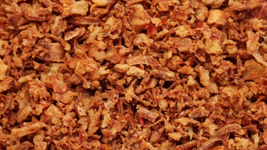crispy onions , rotation in circle. Traditional fried crispy onions backed in flour , Turning. selective focus. yellow background, fast food	