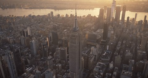 Стоковое видео: New York City Business Center From Above. Aerial Arc Footage of a Famous Art Deco Skyscraper. Helicopter View on an Impressive Tourist Landmark. Manhattan Panorama with Empire State Building Spire