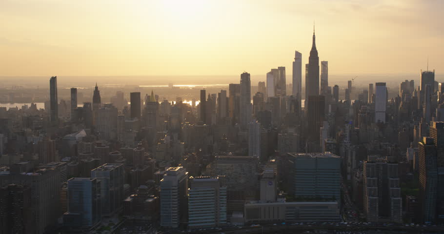Beautiful Cinematic Aerial Sunset Footage of New York City Skyscrapers and Busy City Streets with Car Traffic. Panoramic Helicopter View of Lower Manhattan Office Buildings Royalty-Free Stock Footage #1106171289