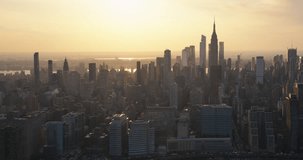 Beautiful Cinematic Aerial Sunset Footage of New York City Skyscrapers and Busy City Streets with Car Traffic. Panoramic Helicopter View of Lower Manhattan Office Buildings