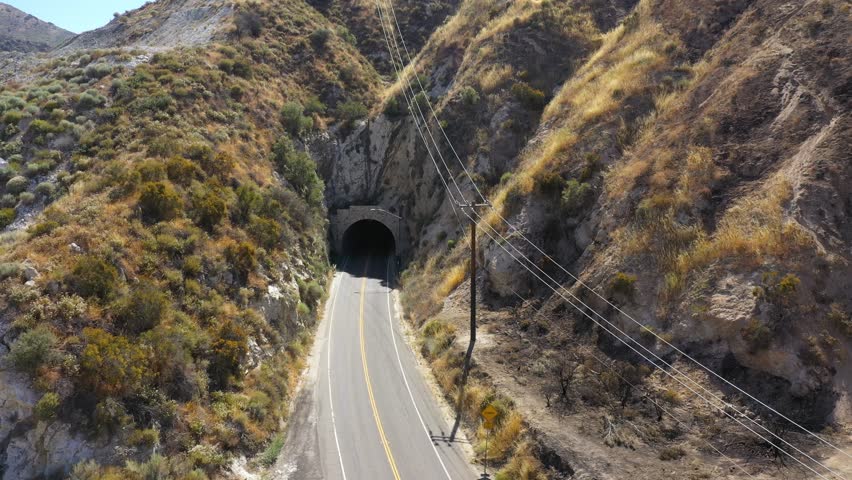 USA, California, Santa Clarita, "Duel" scene tunnel on Soledad Canyon road in the desert near Los Angeles. Drone aerial view of the famous tunnel dug in the cliffs
