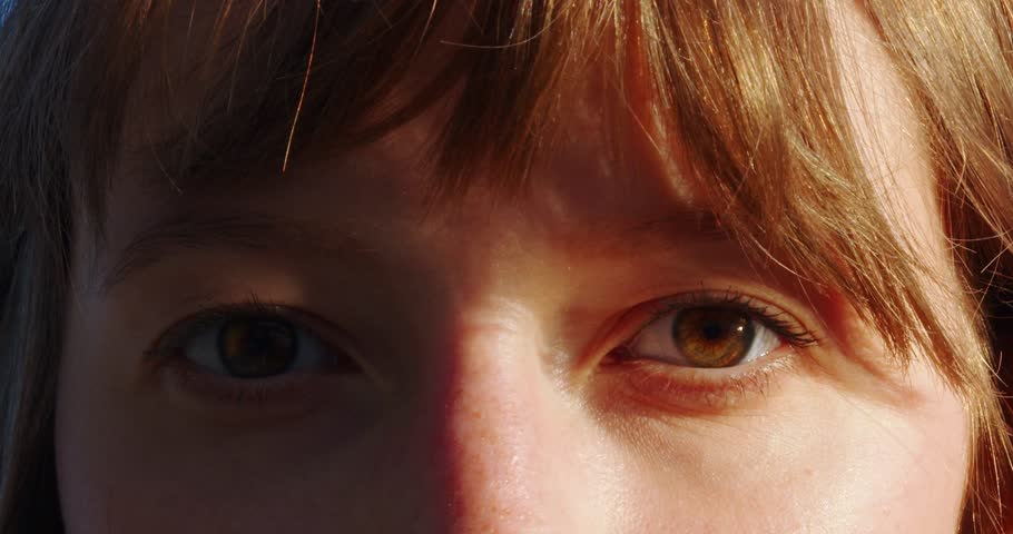 Close-up shot of woman brown eye with light make-up opening and looking at the sun slow motion. The red-haired girl's eyes open. Slow motion. 120FPS. Macro eye photography. The face of a beautiful Royalty-Free Stock Footage #1106176453