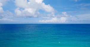 Aerial video over the sea, blue sky, blue sea. Aerial view blue sea horizon as far as the eye can see One part sky, one part sea. High quality video 4K DCI