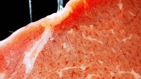 Succulent Australian beef sirloin, perfectly preserved in a vacuum pack. Witness it's tenderness and marbling in a mesmerizing macro video. Frozen meat concept. Beef background. 4K
